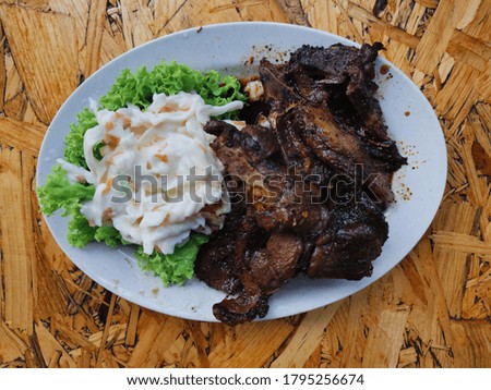 A picture of delicious grilled lamb serving with coleslaw. 