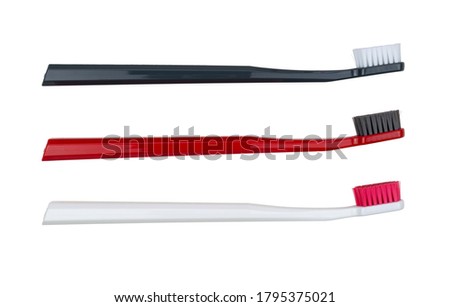 New toothbrushes - white, red and black - isolated on a white background - side view Royalty-Free Stock Photo #1795375021