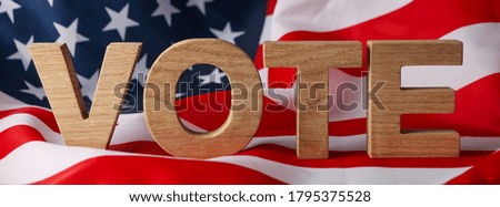 American flag with word Vote made of wooden letters