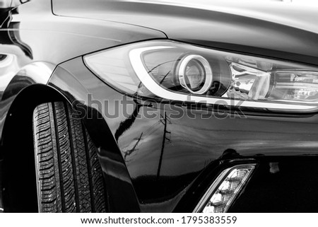Car headlight close up, detailed macro shot of design unbranded, black and white, abstract Royalty-Free Stock Photo #1795383559
