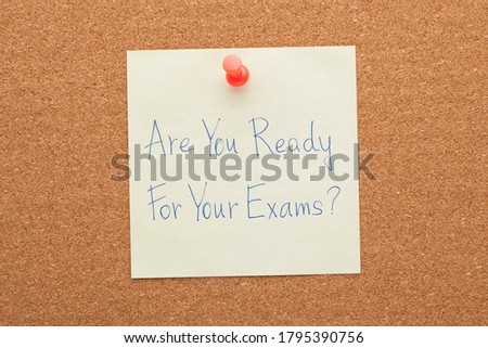 Are You Ready For Your Exams handwritten note pinned on cork board. 