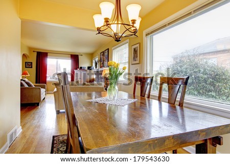 Yellow tones living and dining rooms. Open wall design.