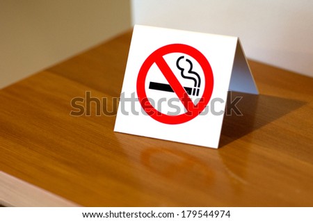 No smoking sign on a shelf of hotel room. Concept photo of banning smoking in public area, medical, health, free smoking, hazard and addiction. No people. Copy space