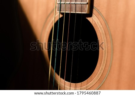 Close-up guitar with half sun highlight and shadow