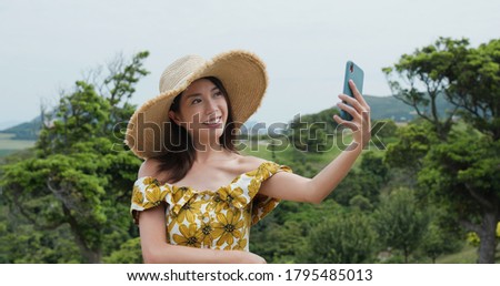 Woman take selfie on cellphone at countryside