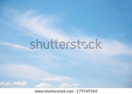 Spindrift white clouds on light blue clear sky at sunny summer day