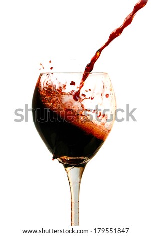 Red Wine pours into, onto, and around a wine glass filling it, spilling it and making a mess all over. Photographed with a fast shutter speed of up to 4000th of a second for beautiful stop motion. 