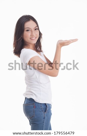 Beautiful Asian girl in jeans and white t-shirt smiling on white background.