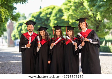 group of graduation students in the park looking happy Royalty-Free Stock Photo #1795573957
