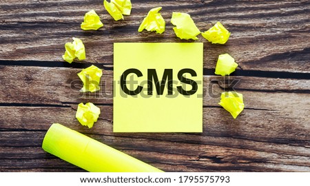 CMS . Notes about CMS ,concept on yellow stickers on wooden background