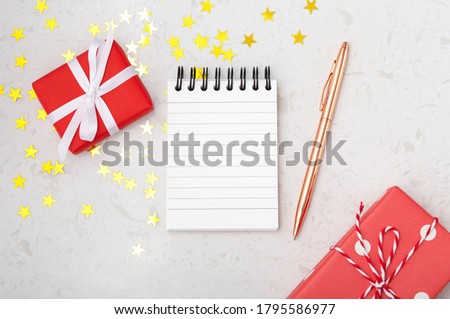 Christmas planning concept with notebook pen on marble table