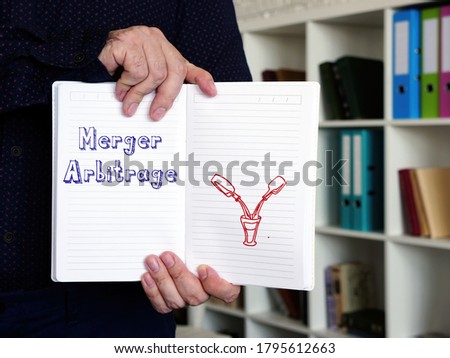 Business concept meaning Merger Arbitrage with inscription on the piece of paper. Royalty-Free Stock Photo #1795612663