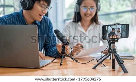 Young business people recording a podcast in a studio