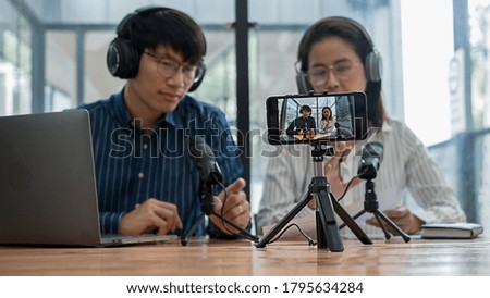 Young business people recording a podcast in a studio