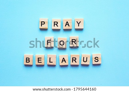 words Pray for Belarus on blue background. peaceful protest for Freedom for Belarus. concept of Praying, mourning, humanity.