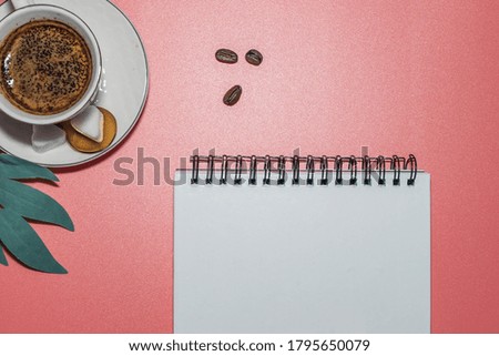 Blank notepad white page on pink desk, color background. Top view, empty space for text. Woman workspace desk with copy space background