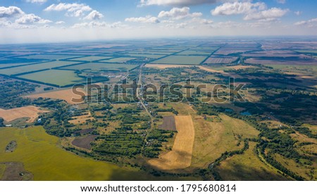 aerial photography of a village located among forests and fields