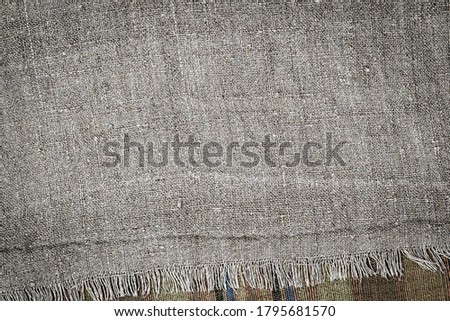Vintage linen cloth texture background. Old  flax fabric Backdrop. Hemp tablecloth frame with fringe