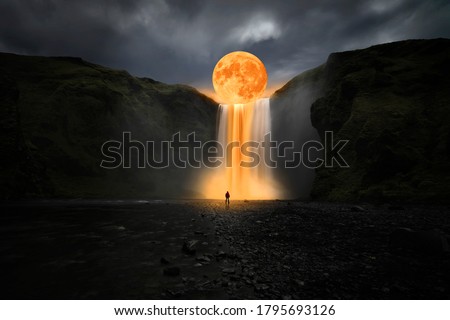 Orange moon over great waterfall Royalty-Free Stock Photo #1795693126
