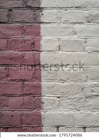 Textured abstract background of brick street wall with paint spot