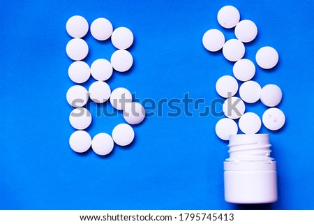 pictured in the photo white tablets on purple background. top view