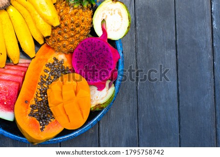 tropical fruits background. Pineapples, bananas, watermelon, pap