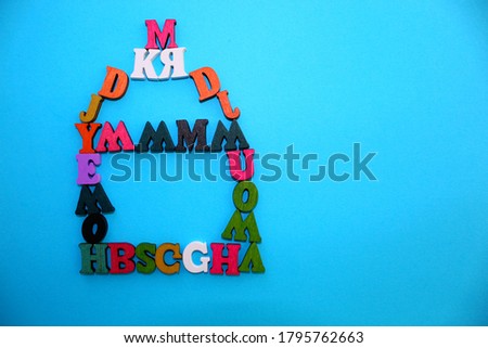 The letters of the alphabet are laid out on a blue background in the form of a house. Beautiful color font.