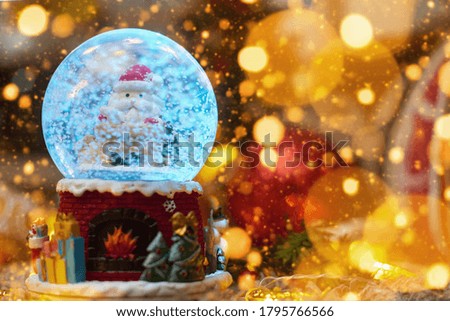 postcard ,christmas ball with snow and santa claus and toys, bokeh, flatley, copyspace