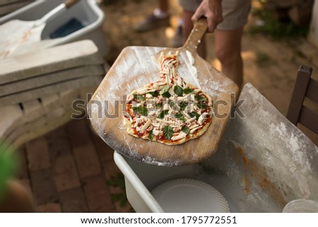 Overhead view of homemade pizza at campsite