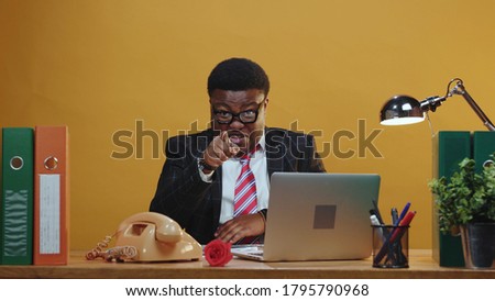 Emotional black manager executive talks on camera giving inspirational speech thumbs up gesturing positive smile cheerful while sitting in the office. Copy space. Royalty-Free Stock Photo #1795790968