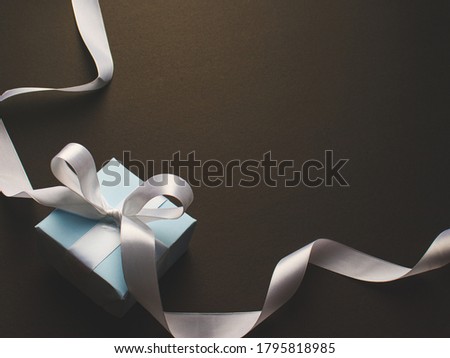 Blue gift box with white ribbon stock image.
