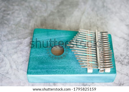 Kalimba or mbira is an African musical instrument.Traditional to the Shona people of Zimbabwe. Kalimba made from  wooden board with metal, play on  hands and plucking the tines with the thumbs