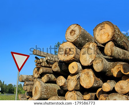 Harvesting timber logs in a forest and limiting traffic sign