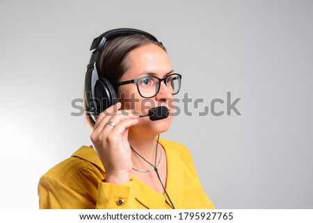 people, online service, communication and technology concept - smiling female helpline operator with headset over grey background