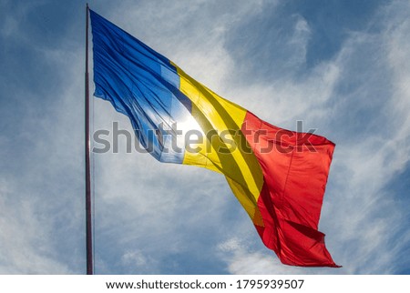 Romanian flag waving in sunlight