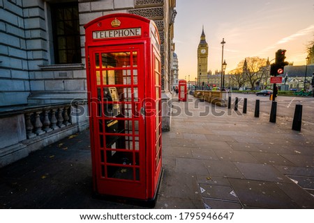 Red telephone box and Big Ben at sunrise in London