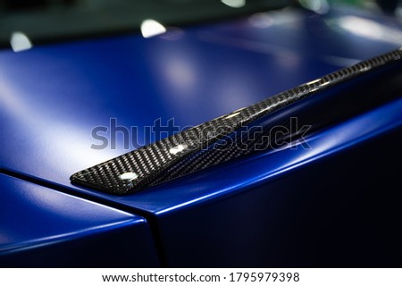 Detail of car rear spoiler carbon fiber texture finished Royalty-Free Stock Photo #1795979398