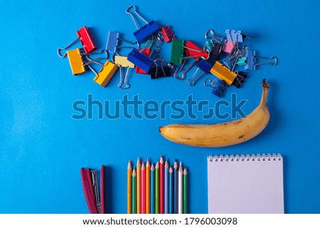 different stationary items and notebooks on the blue background. minimalism. flat lay