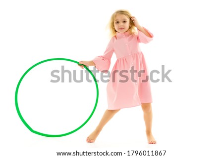 Adorable Blonde Girl Playing or Exercising with Hula Hoop