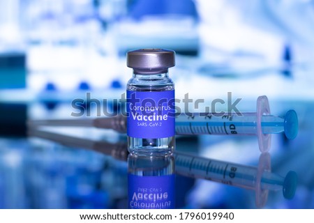 Omicron Vaccine Covid-19 - American vaccine Coronavirus Sars-Cov-2 with the USA flag in the background Royalty-Free Stock Photo #1796019940