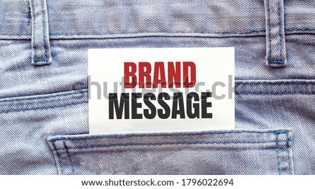 BRAND MESSAGE words on a white paper stuck out from jeans pocket. Business concept
