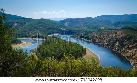 Meander of Melero surrounded by mountains on a day with blue sky, Riomalo de Abajo, Las Hurdes, Cáceres, Spain Royalty-Free Stock Photo #1796042698