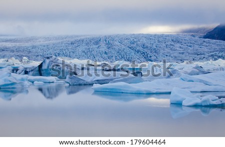 Beatufil vibrant picture of icelandic glacier and glacier lagoon with water and ice in cold blue tones