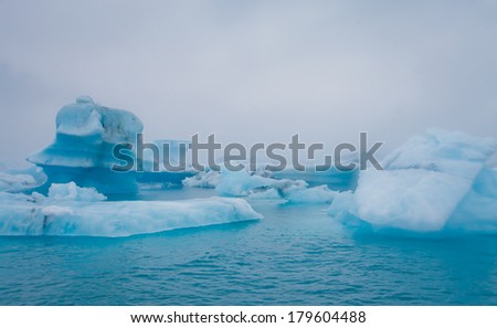 Beatufil vibrant picture of icelandic glacier and glacier lagoon with water and ice in cold blue tones