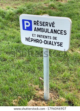 French sign at the hospital translated as Reserved for ambulances and patient of nephro-dialyzed