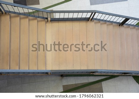 Top view shot of beautiful stairway down from high level to the ground of modern style building with nobody shows the concept of way to success in life or business. It is empty space for frame.