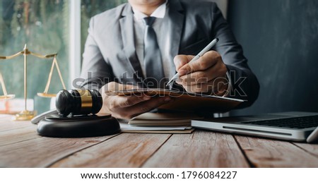 Business and lawyers discussing contract papers with brass scale on desk in office. Law, legal services, advice, justice and law concept Royalty-Free Stock Photo #1796084227