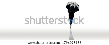 Back view of a lady in a black shirt and blue jeans walking with a black umbrella isolated on white. Shot of lady with black umbrella walking isolated on white.