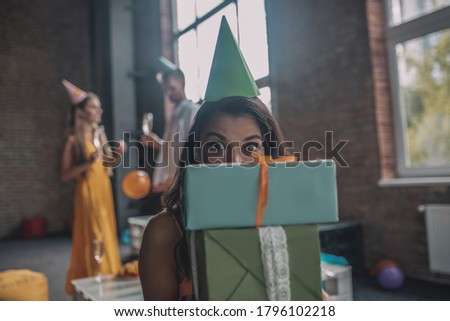 Lots of gifts. A woman holding boxes with her birthday presents