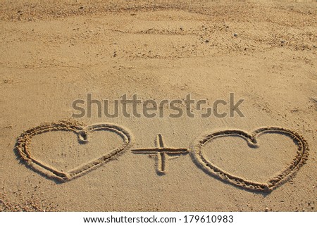 Couple of hearts shape drawn on beach sand